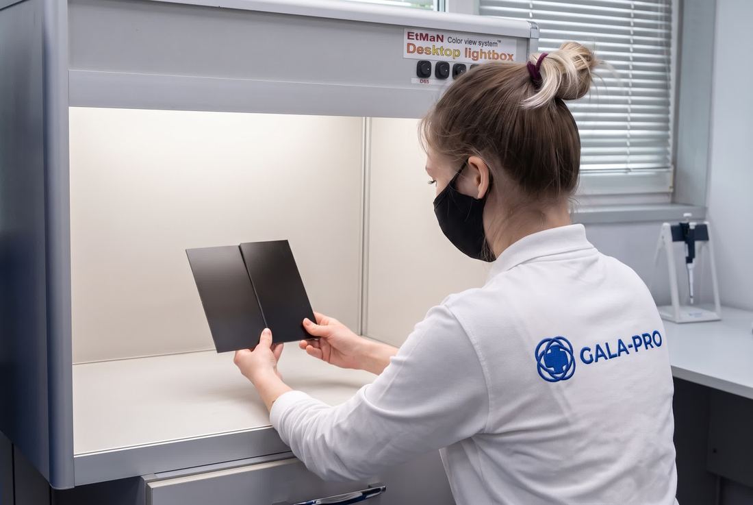 Colourist verifying a sample in a lightbox